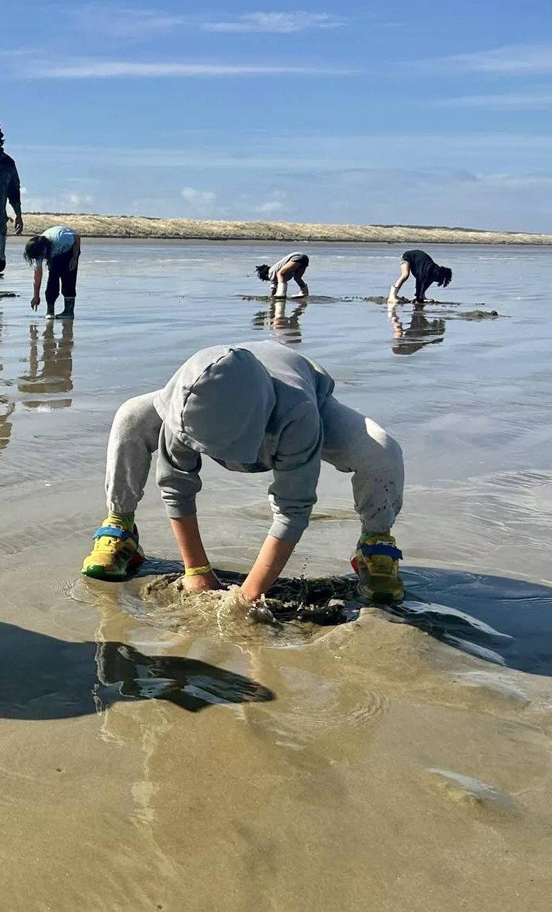 child digging for shellfish
