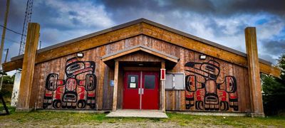 Front of meeting house with painted fronts and wooden posts 