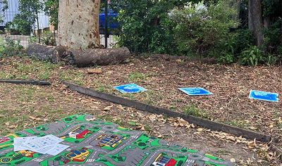 Smiling toddler playing with toitoi feather 