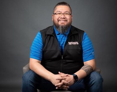 Man sitting on chair with red sneakers