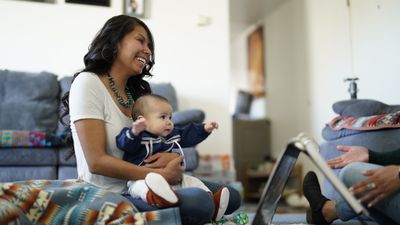 Woman holding baby in front of canyon