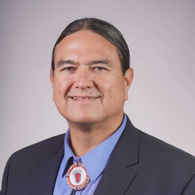 Man wearing suit wearing bolo tie
